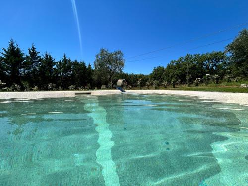 a person standing next to a pool of water at Agriturismo San Ansanino in Pari