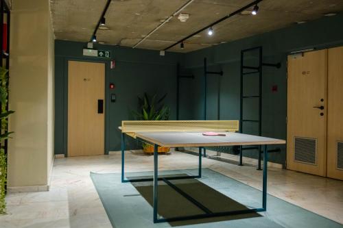 a ping pong table in a room with green walls at Citybox Brussels in Brussels