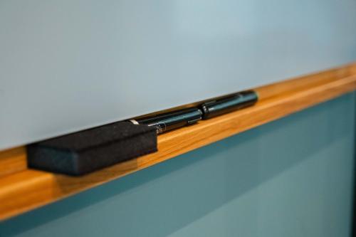 two devices sitting on top of a wooden shelf at Citybox Brussels in Brussels