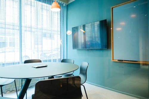 a meeting room with a white table and chairs at Citybox Brussels in Brussels