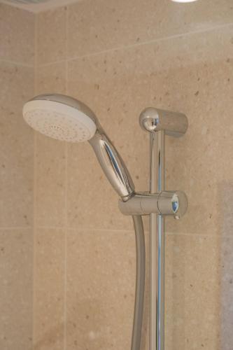 a shower with a shower head in a bathroom at Citybox Brussels in Brussels