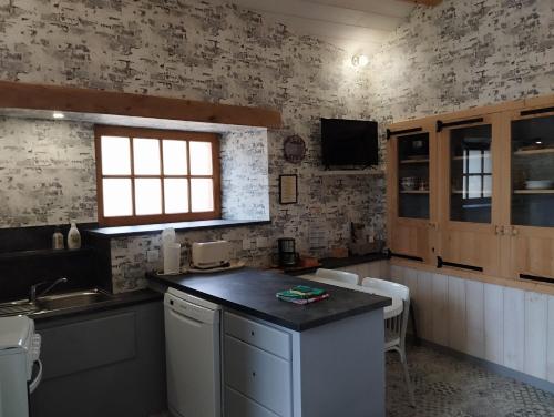 a kitchen with a sink and a counter top at LA FORGE DU LUCIMOND in Saint-André