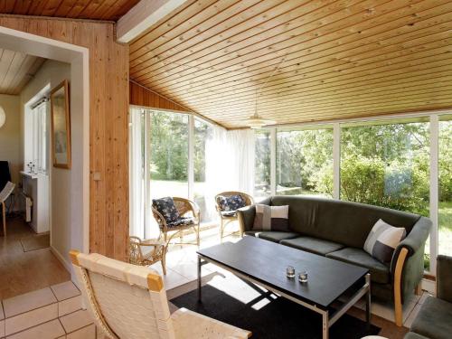 a living room with a couch and a table at 8 person holiday home in Fjerritslev-By Traum in Slettestrand