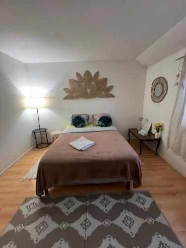 a bedroom with a bed in a room with a rug at Roissy CDG, private room 1 in Roissy-en-France