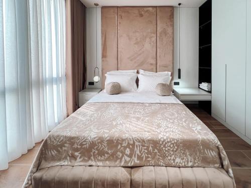 a bedroom with a large bed with white pillows at Tirana Bliss Appartment 101 in Tirana