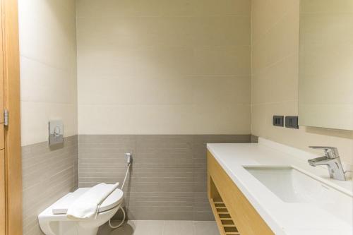 a bathroom with a toilet and a sink at Jounieh Living - Residences by Local Host in Ed Dkârîne