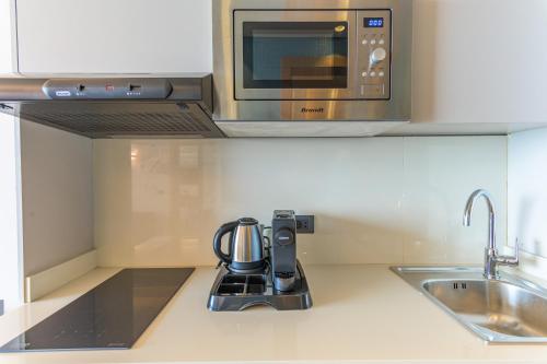 a kitchen with a coffeemaker on a kitchen counter at Jounieh Living - Residences by Local Host in Ed Dkârîne