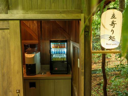 a room with a coffee maker and a drink cooler at Mizunoto Reopening on April 1, 2025 in Hakone