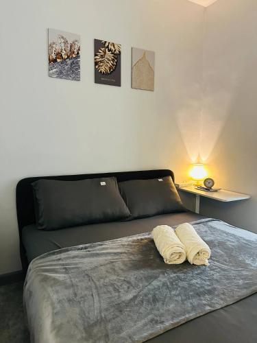 a bedroom with a bed with two towels on it at Cozy Staycation with Netflix, Pool, PS4, Board Games in Manila