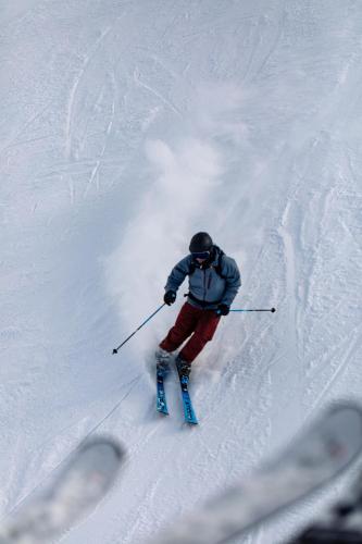 a person is skiing down a snow covered slope at SCHLOSS Zermatt - CBD & Adaptogenic Spa and Sport Hotel in Zermatt
