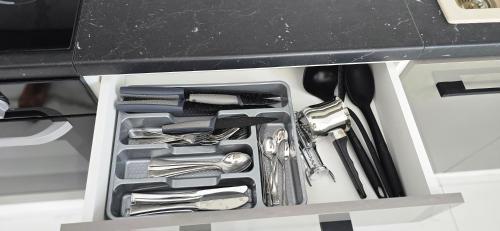a drawer filled with utensils in a kitchen counter at Casa Elia AXD in Alexandroupoli