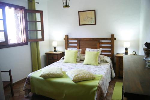 a bedroom with a bed with two pillows on it at Casas del Monte in Valverde