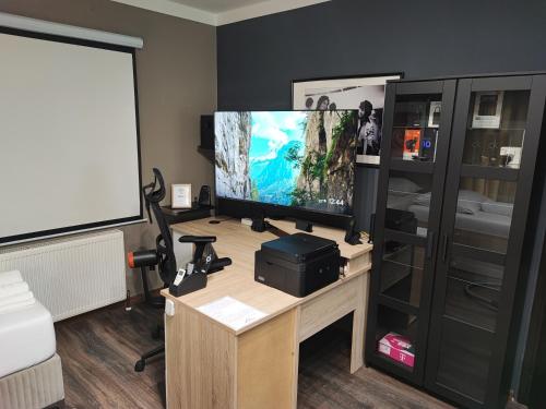 an office with a desk with a computer monitor on it at ZAGORA HILLS Premium Apartman SELF CHECK-IN, FREE PARKING in Krapina