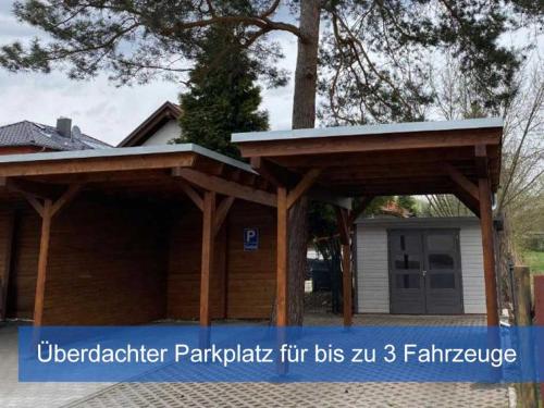 a house with a wooden pavilion in front of it at Ideal für Kinder - Familientreffen - Ferienhaus Elbharmonie - Hunde herzlich willkommen in Dresden