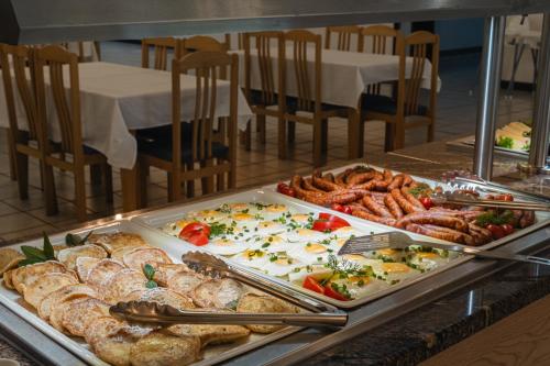a buffet with many different types of food on display at Rewita Rogowo k Kołobrzegu in Rogowo
