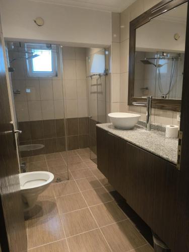a bathroom with a sink and a toilet and a mirror at Safari Suit Hotel , Side in Side