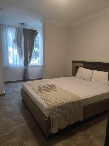 a bedroom with a bed with towels on it at Safari Suit Hotel , Side in Side