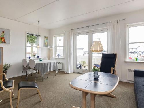 a living room with a table and chairs at Harbor Retreat in Rudkobing - By Traum Ferienwohnungen in Rudkøbing