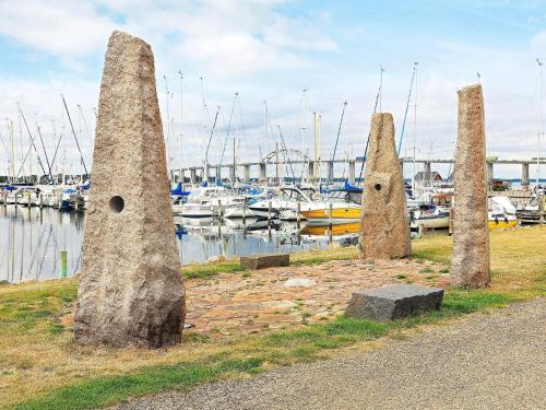 a group of three stone pillars next to a marina at Harbor Retreat in Rudkobing - By Traum Ferienwohnungen in Rudkøbing