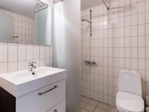 a white bathroom with a sink and a toilet at Harbor Retreat in Rudkobing - By Traum Ferienwohnungen in Rudkøbing