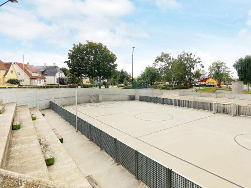 a tennis court with two basketball nets on it at Harbor Retreat in Rudkobing - By Traum Ferienwohnungen in Rudkøbing