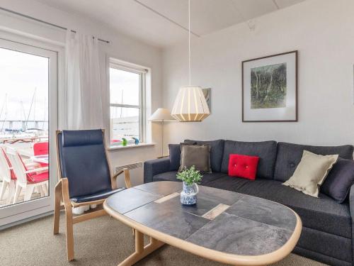 a living room with a couch and a table at Harbor Retreat in Rudkobing - By Traum Ferienwohnungen in Rudkøbing