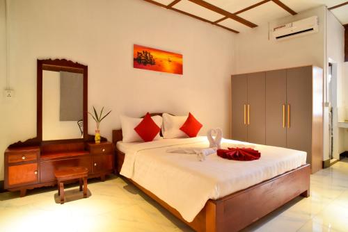 a bedroom with a bed with a dresser and a mirror at Studio Ground Floor Room by Densy Angkor in Siem Reap
