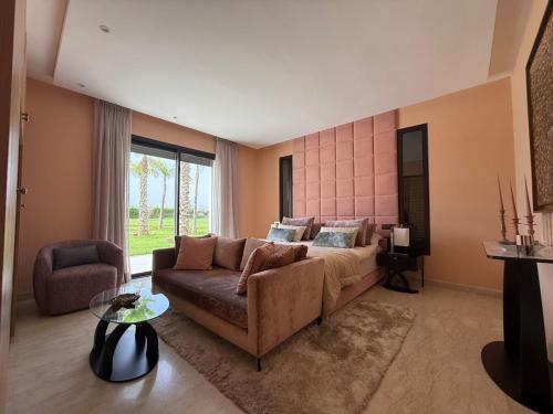 a living room with a couch and a bed at Luxury Villa Pool with Atlas View in Moussiha