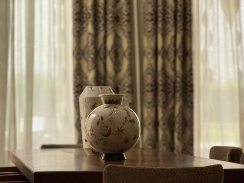 a vase sitting on top of a table at Luxury Villa Pool with Atlas View in Moussiha