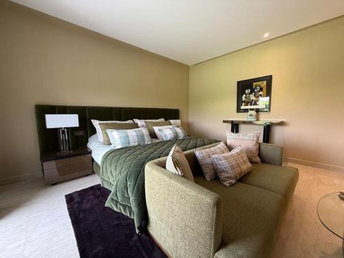 a large bedroom with a bed and a couch at Luxury Villa Pool with Atlas View in Moussiha