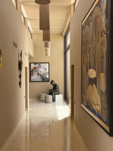a hallway with a painting and a statue in a museum at Luxury Villa Pool with Atlas View in Moussiha