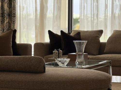 a living room with two couches and a glass table at Luxury Villa Pool with Atlas View in Moussiha