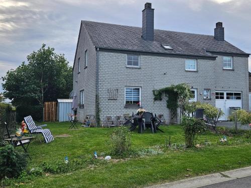a house with a yard with a table and chairs at Comfort Stay in Carlsbourg in Carlsbourg