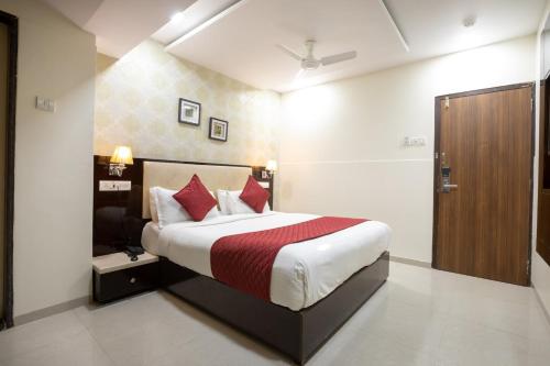 a bedroom with a bed and a television in it at Hotel Laaiba Residency in Mumbai