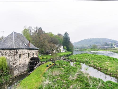 an old stone building next to a river at Comfort Stay in Carlsbourg in Carlsbourg