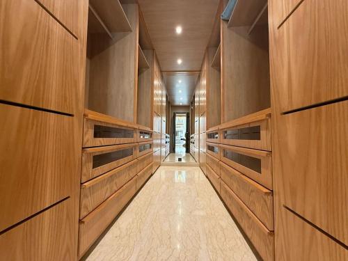 a hallway with wood paneled walls and a long corridor at Luxury Villa Pool with Atlas View in Moussiha