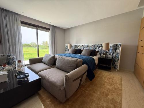 a bedroom with a bed and a couch at Luxury Villa Pool with Atlas View in Moussiha