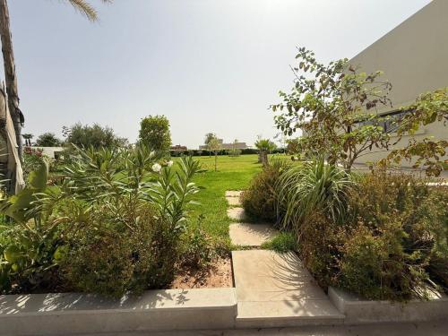 a garden with plants and a field in the background at Luxury Villa Pool with Atlas View in Moussiha