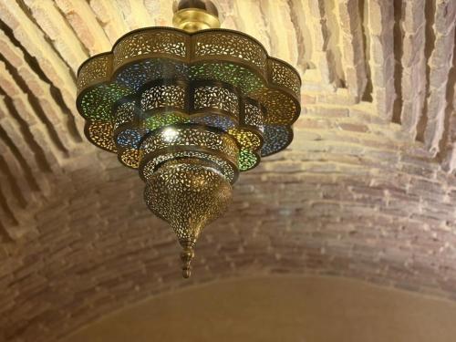 a chandelier hanging from a ceiling in a room at Luxury Villa Pool with Atlas View in Moussiha