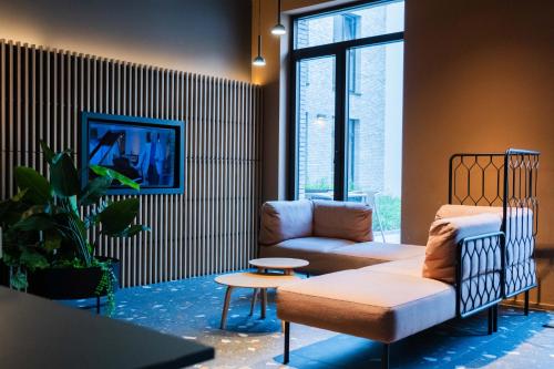 a living room with a couch and a chair at Citybox Antwerp in Antwerp