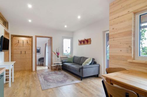 a living room with a couch and a table at Pension Ferienwohnung Baarblick in Donaueschingen