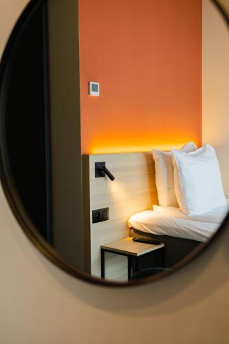 a mirror reflection of a bed in a room at Citybox Antwerp in Antwerp