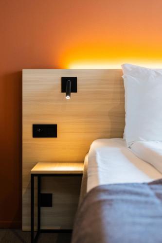 a bedroom with a bed and a nightstand next to a bed sidx sidx sidx at Citybox Antwerp in Antwerp