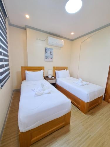 Ένα ή περισσότερα κρεβάτια σε δωμάτιο στο Tungkip House Bed and Breakfast