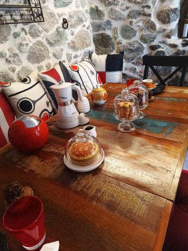 a wooden table with food on top of it at LA TANA DELLA VOLPETTA - Bed & Breakfast in Stella