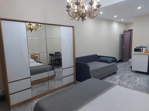 a living room with a couch and a mirror at Arte Mia suite in Reggio Calabria