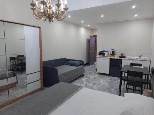 a living room with a couch and a kitchen at Arte Mia suite in Reggio Calabria