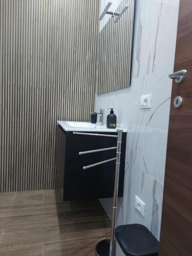 a small bathroom with a sink and a mirror at Arte Mia suite in Reggio Calabria