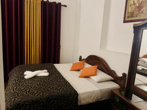 a bedroom with a bed with two towels on it at Lakshmi Illam in Nuwara Eliya