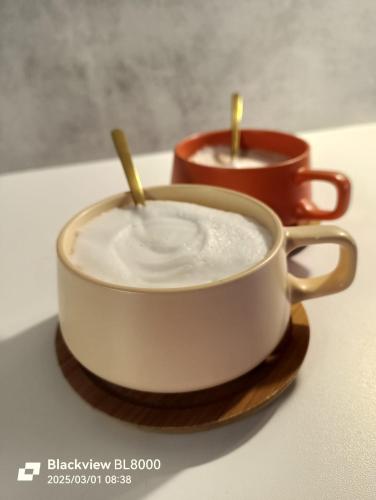 two cups of coffee with wooden sticks in them at LA TANA DELLA VOLPETTA - Bed & Breakfast in Stella